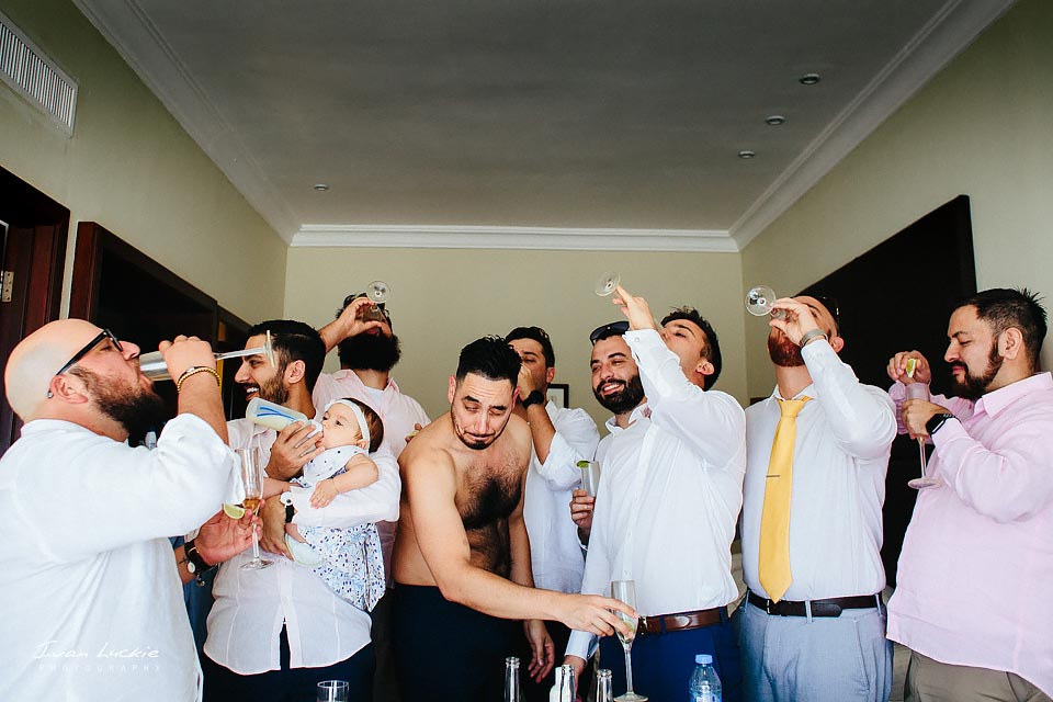 groom and friends during getting ready having a tequila shoot