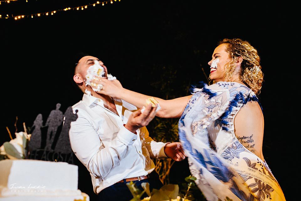 Bride smashing the cake on grooms' face