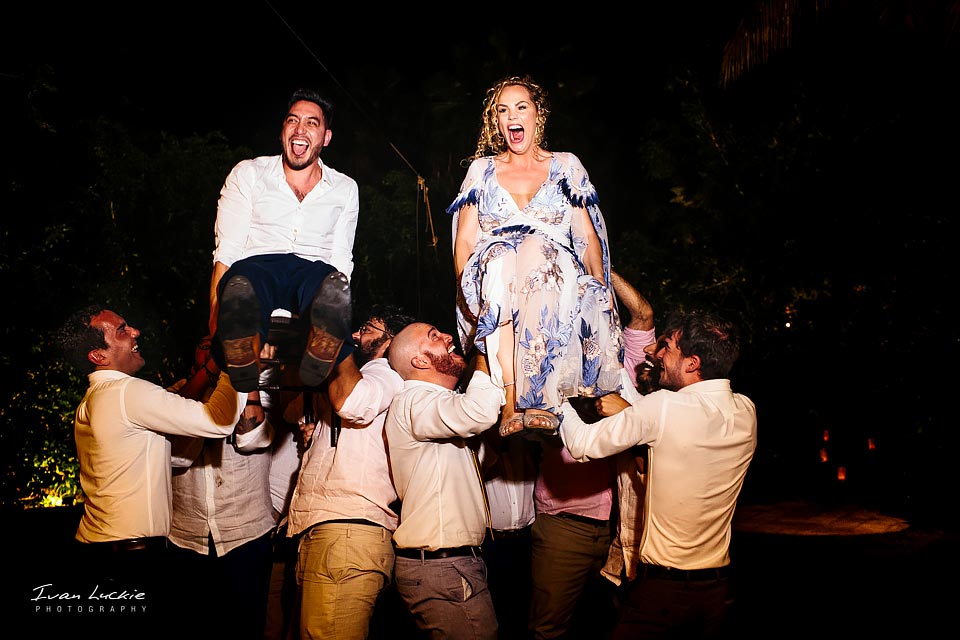 Bride and groom lift on chairs