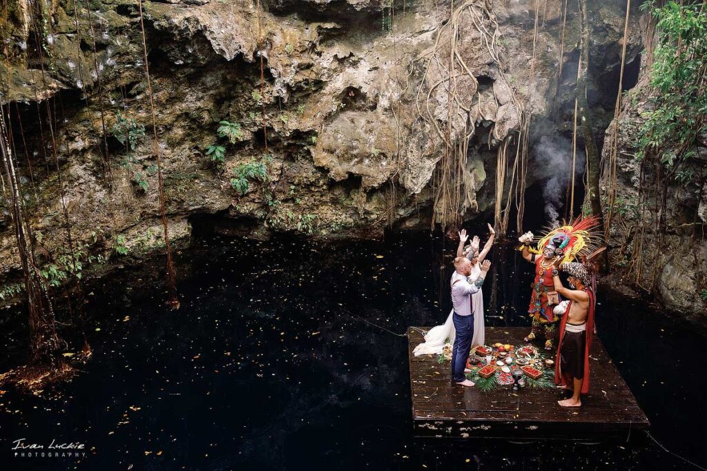 cenote ceremony held on a wooden platform over the water
